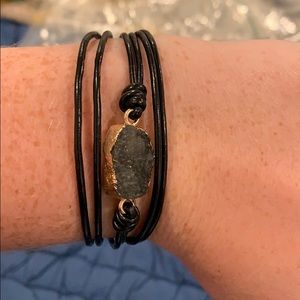 Black and gold bracelet with a gray stone